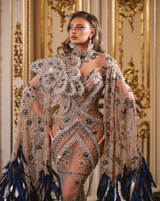 Elegant silver dress adorned with navy blue stones and feathers