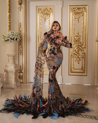 Elegant gown featuring side cape and long sleeve embellished with vibrant feathers