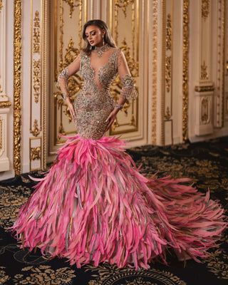 Luxurious fabric pink gown featuring intricate feather design in pink, silver, and gold
