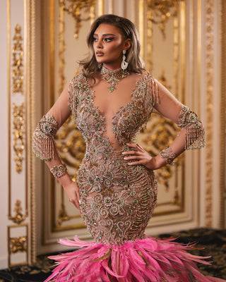 Elegant pink dress adorned with silver and gold beads and feathers