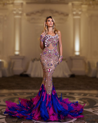 Long feather dress exuding glamour with crystals, stones, and playful feathers.
