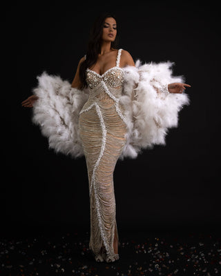 Silver dress with intricate tassels, pearls, and white feathers