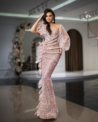 Pink dress featuring wide sleeves and sparkling bead accents
