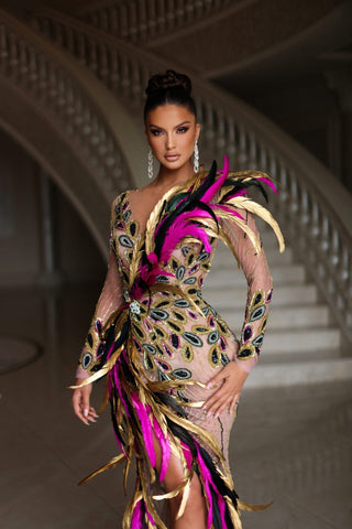 Feather dress in black, gold, and pink hues exudes elegance