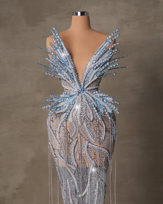 Aera Long Dress featuring butterfly motifs on flowing fabric.

