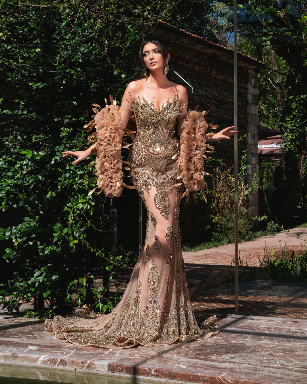 Elegant sleeveless dress with crystal embellishments.
