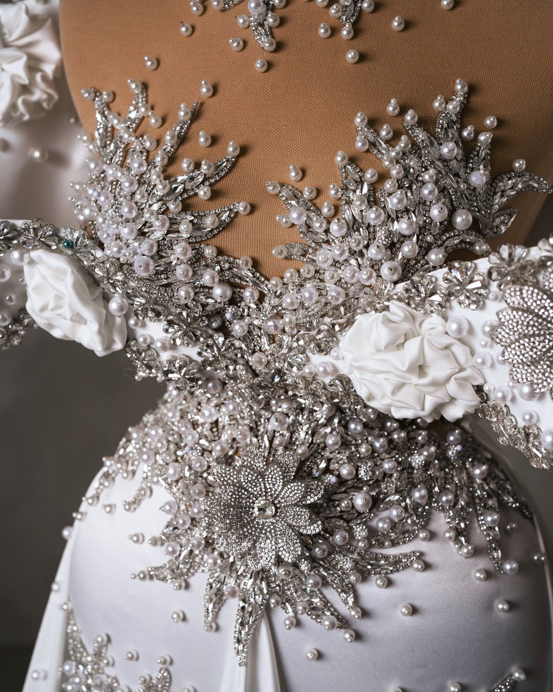 Close-up of bridal dress neck detail with crystals and pearls