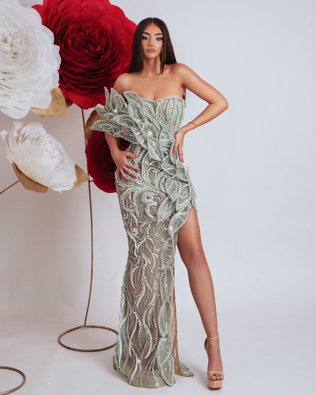 Luxury sleeveless and strapless dress adorned with light green beads and intricate bodice details.