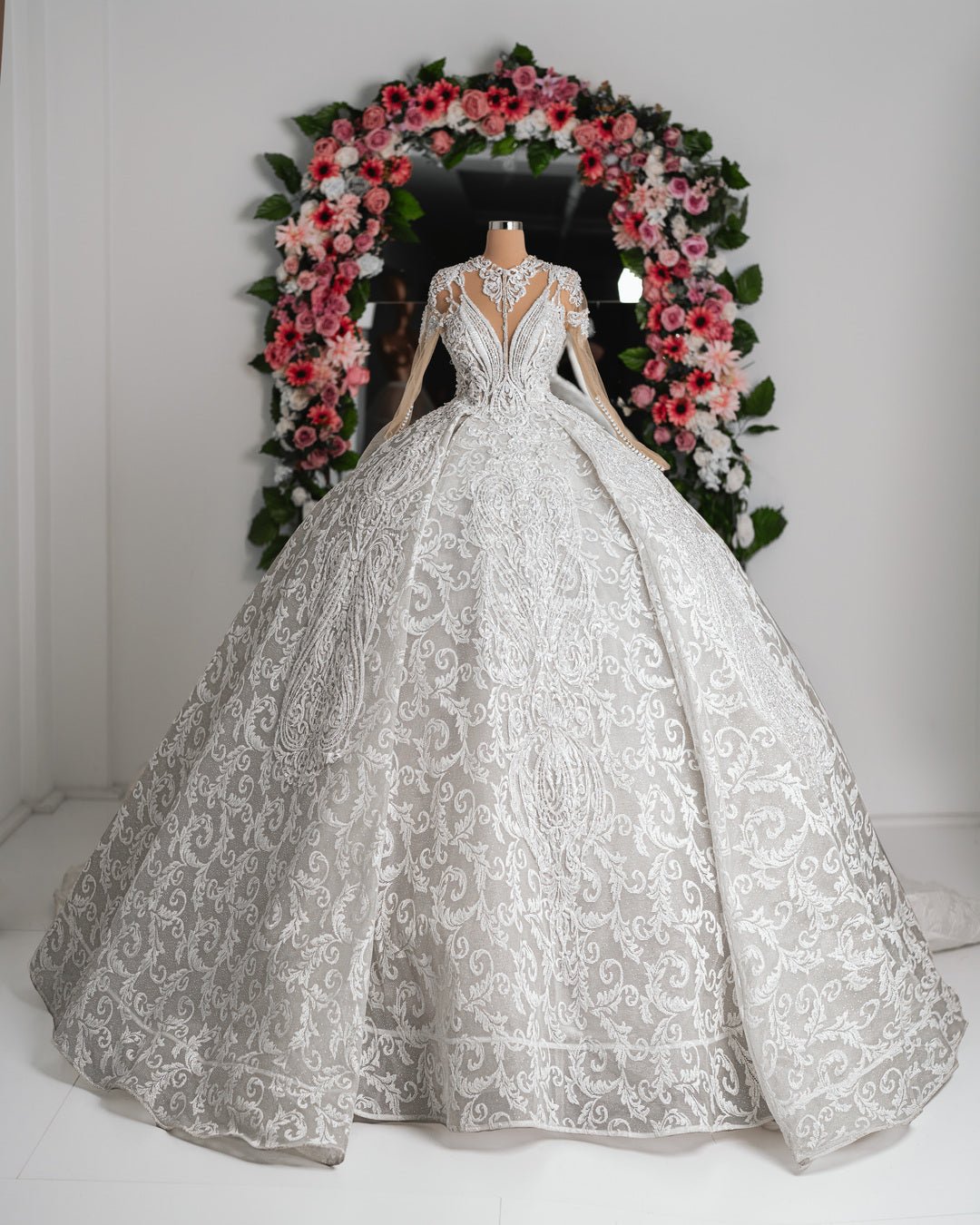 Amber Bridal Dress with delicate floral appliques and a flowing skirt, perfect for a romantic bridal look.