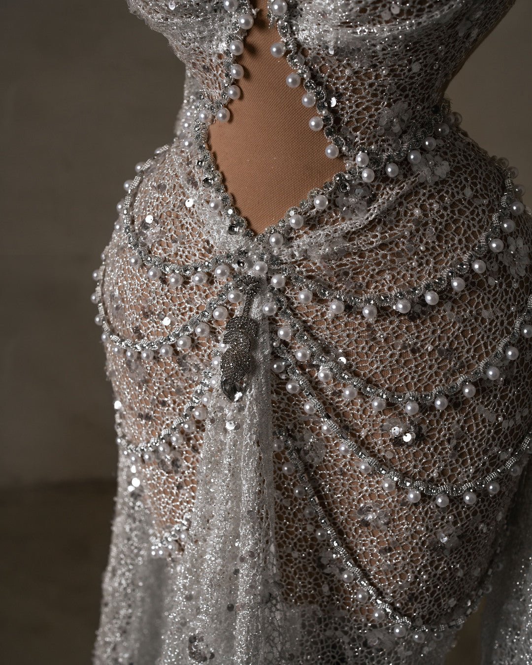 Close-up of hot bridal dress with intricate sequin and pearl detailing
