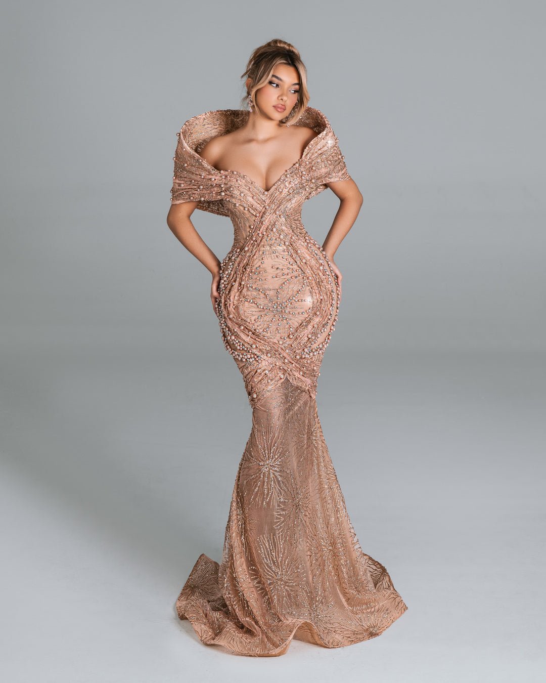 Elegant off-shoulder gown with pearl detailing.