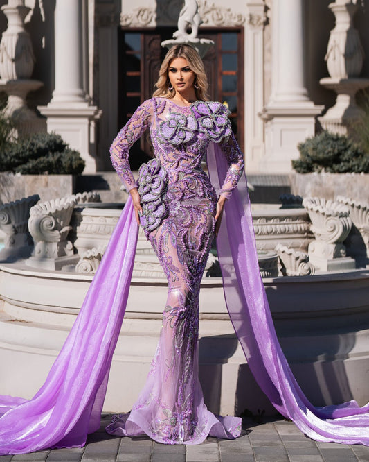 Woman in a flowing purple dress with intricate flower design.