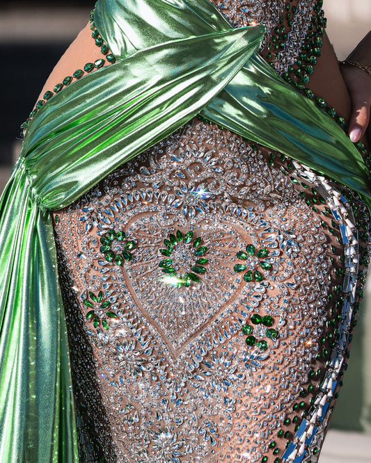 Glamorous green dress adorned with crystals, highlighting a sophisticated silhouette.