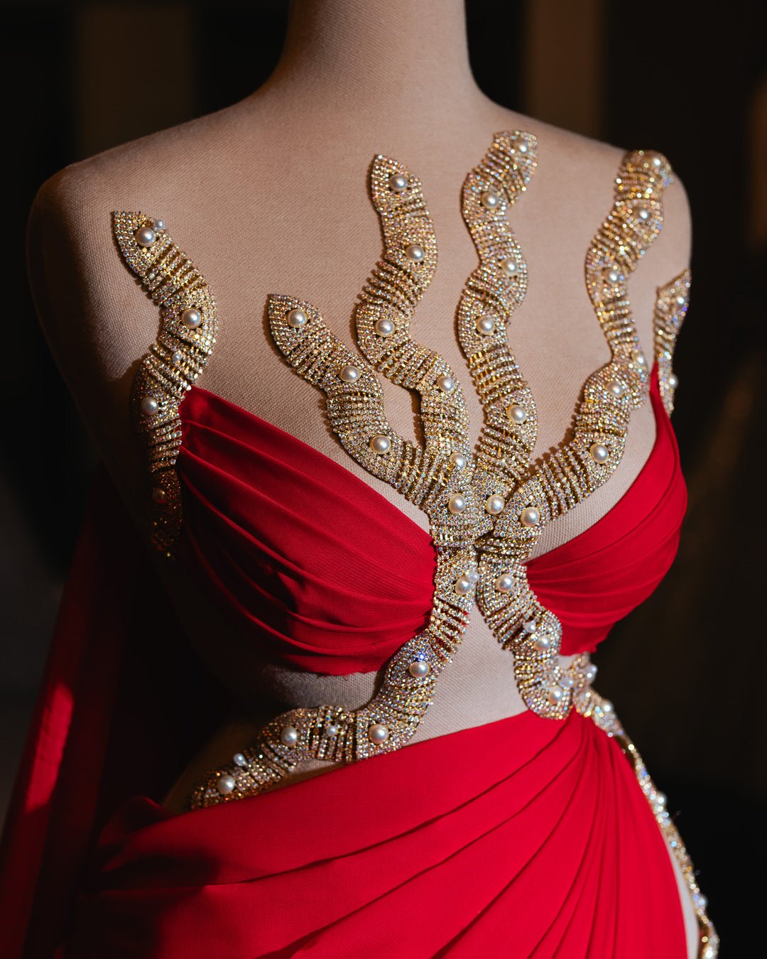 Stunning bohemian-inspired red dress adorned with shimmering gold embellishments, perfect for special occasions.