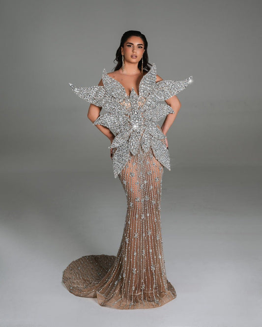Glamorous silver gown with intricate crystal embellishments and 3D floral details.
