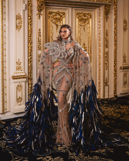 High-neck silver gown with intricate 3D flower embellishment and side capes