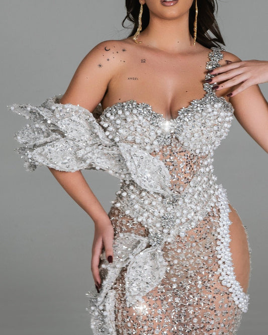 Luxurious off-shoulder dress with intricate floral design.