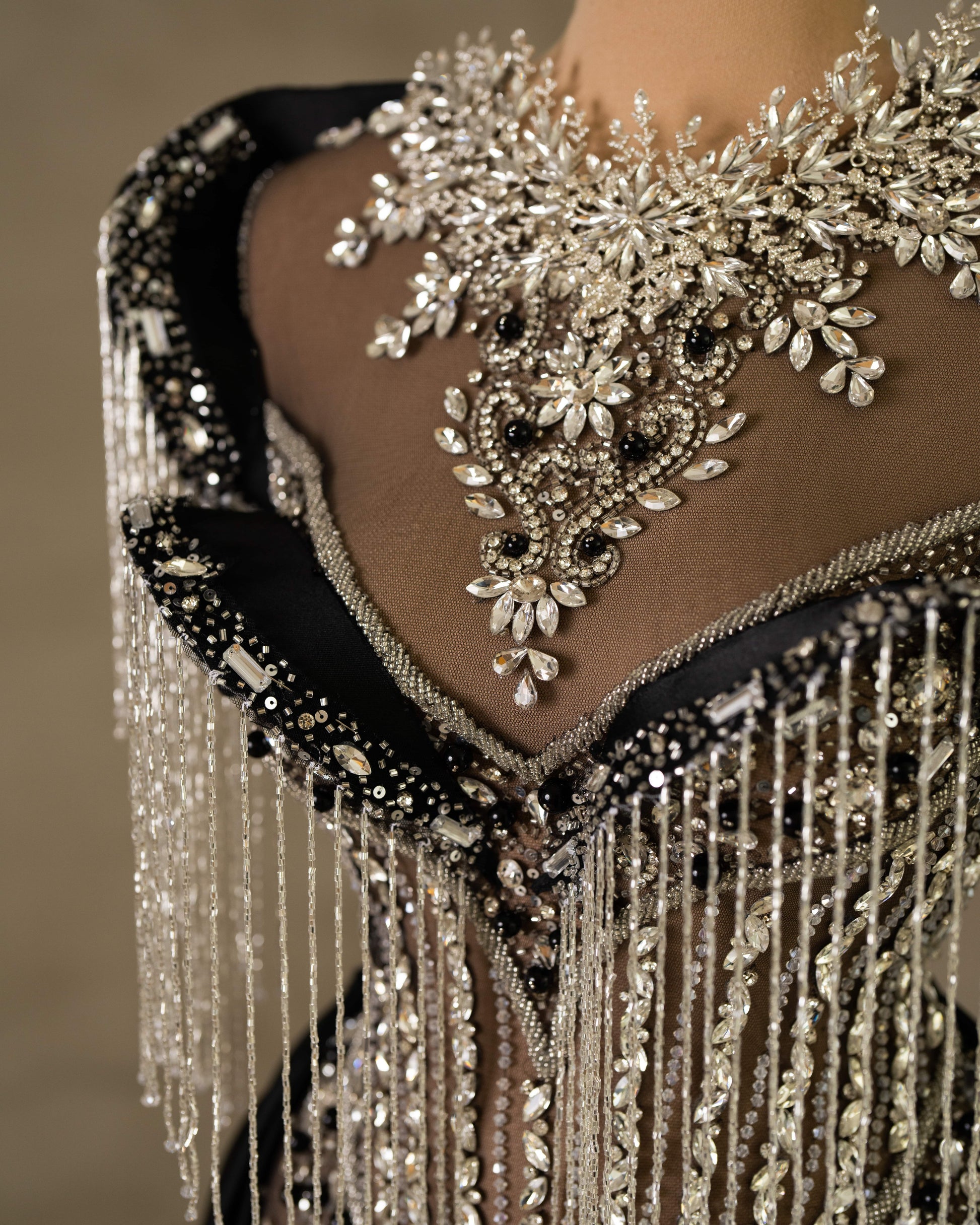 Close-up of hand-set stones and crystals on Black Dress's lace, creating a shimmering texture