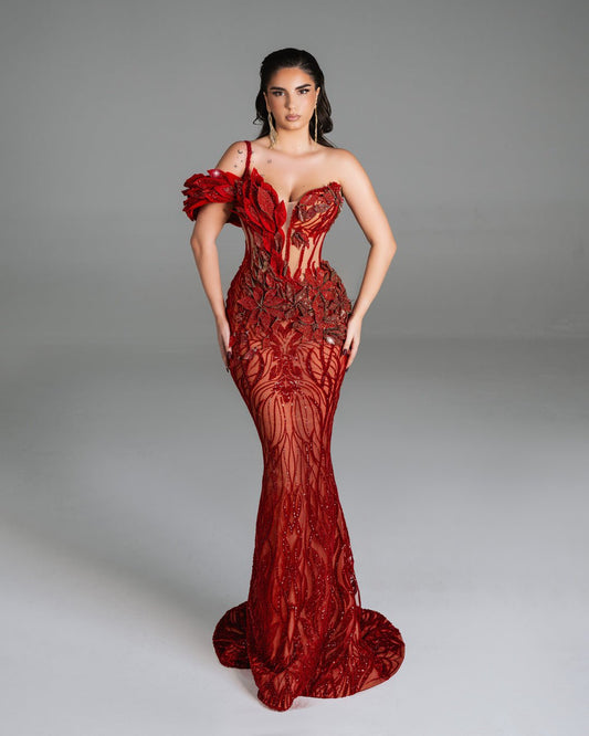 Elegant red gown featuring glittering 3D floral designs and a semi-sheer embroidered skirt.