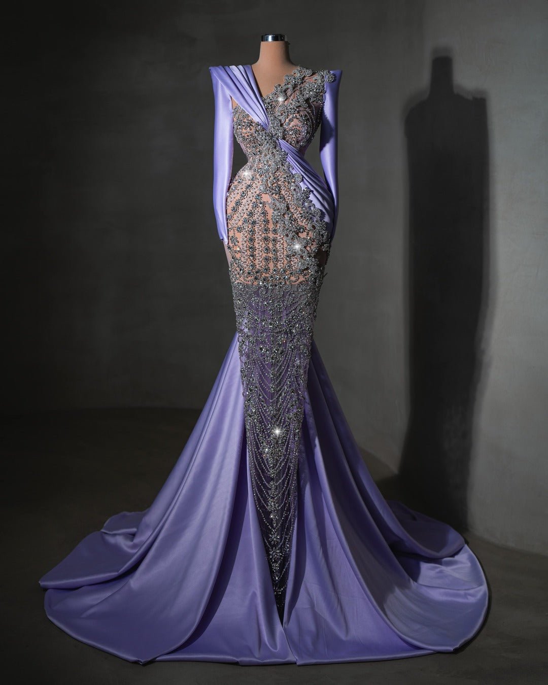 Elegant lavender dress with intricate crystal details and a flowing train, perfect for formal events.