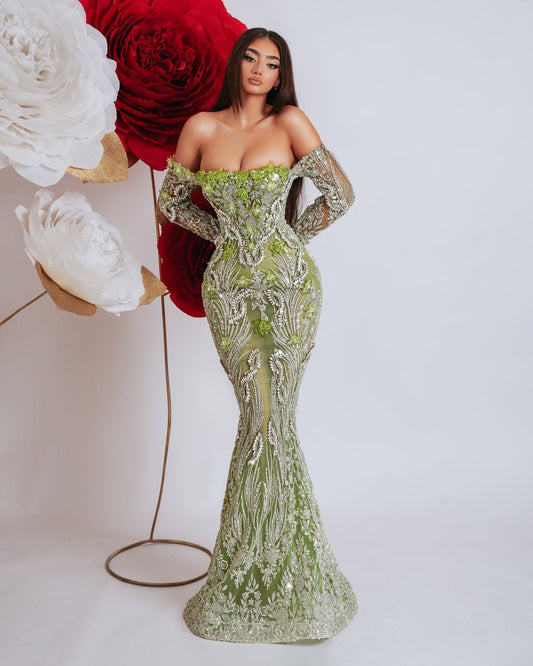 Elegant light green off shoulder dress with long sleeves, embellished with silver stones and green crystals.