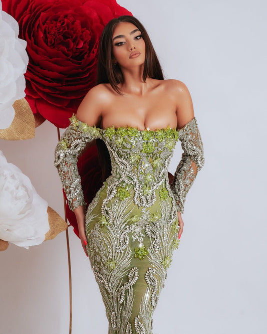 Luxury off shoulder dress in light green with long sleeves and sparkling crystal embellishments.