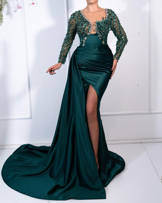 Delisha Emerald Dress with sparkling green crystals, showcasing a stunning, elegant design.