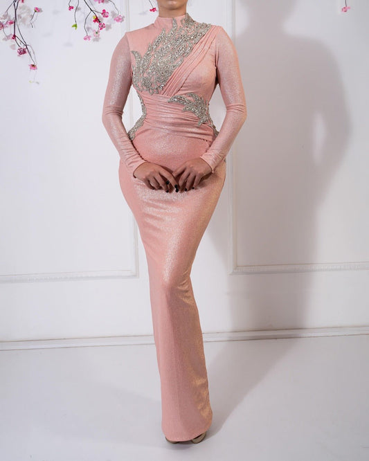 Elegant pink dress with long sleeves and sparkling crystal embellishments.