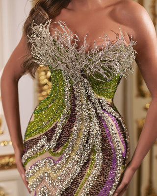 Detailed view of silver, green, and purple stones on sleeveless dress