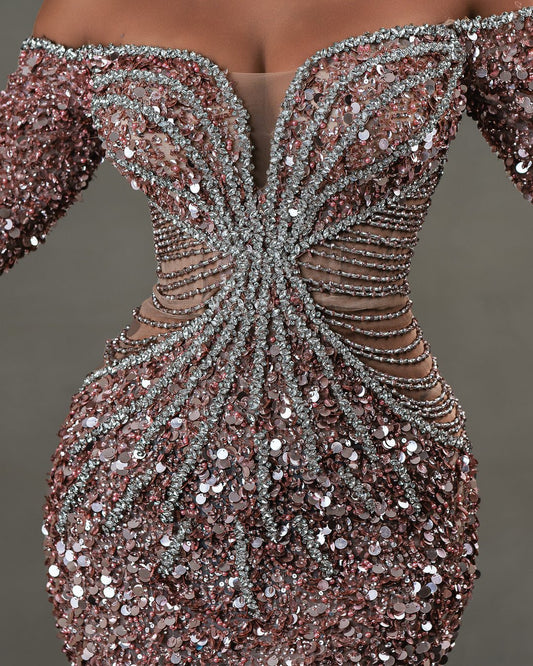 Close-up of silver stone embellishments on light pink dress