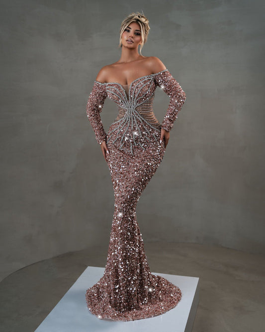 Off-shoulder light pink gown with long sleeves and shimmering silver accents