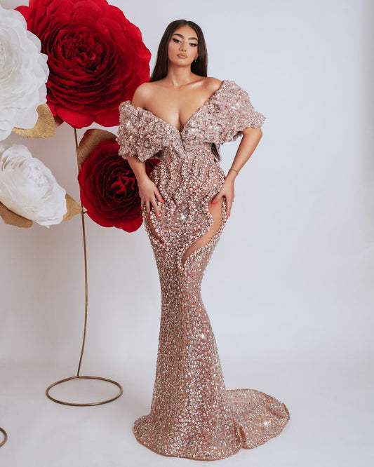 Elegant long off shoulder dress in light pink with bead embellishments.