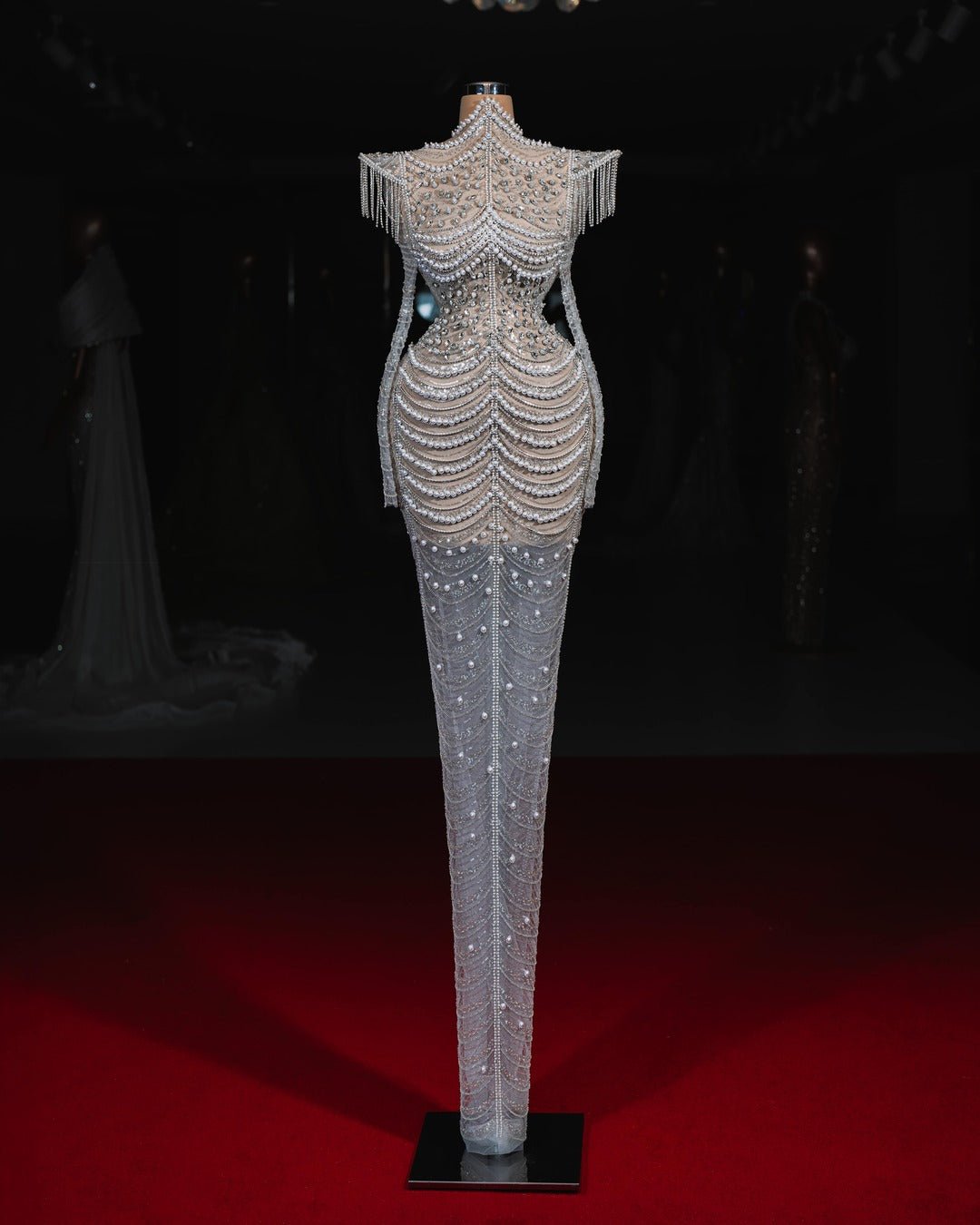 Handmade wedding gown adorned with intricate pearl details, exuding timeless charm.