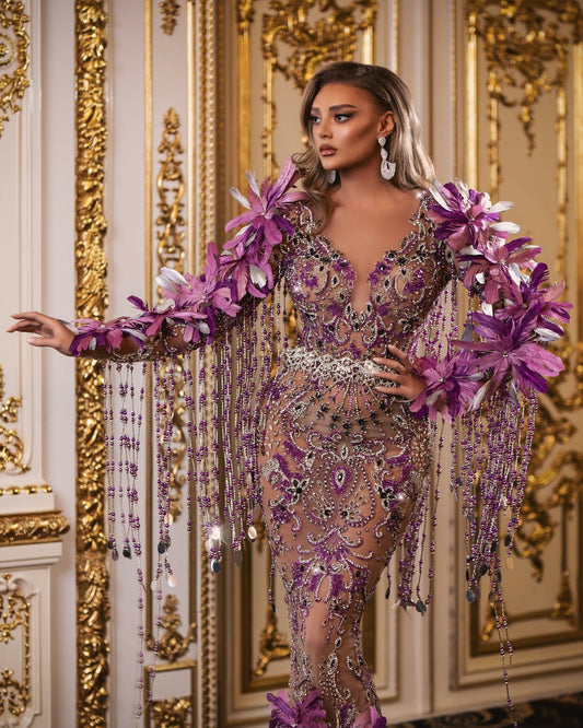 Elegant purple dress adorned with silver and purple stones, beads, and feathers