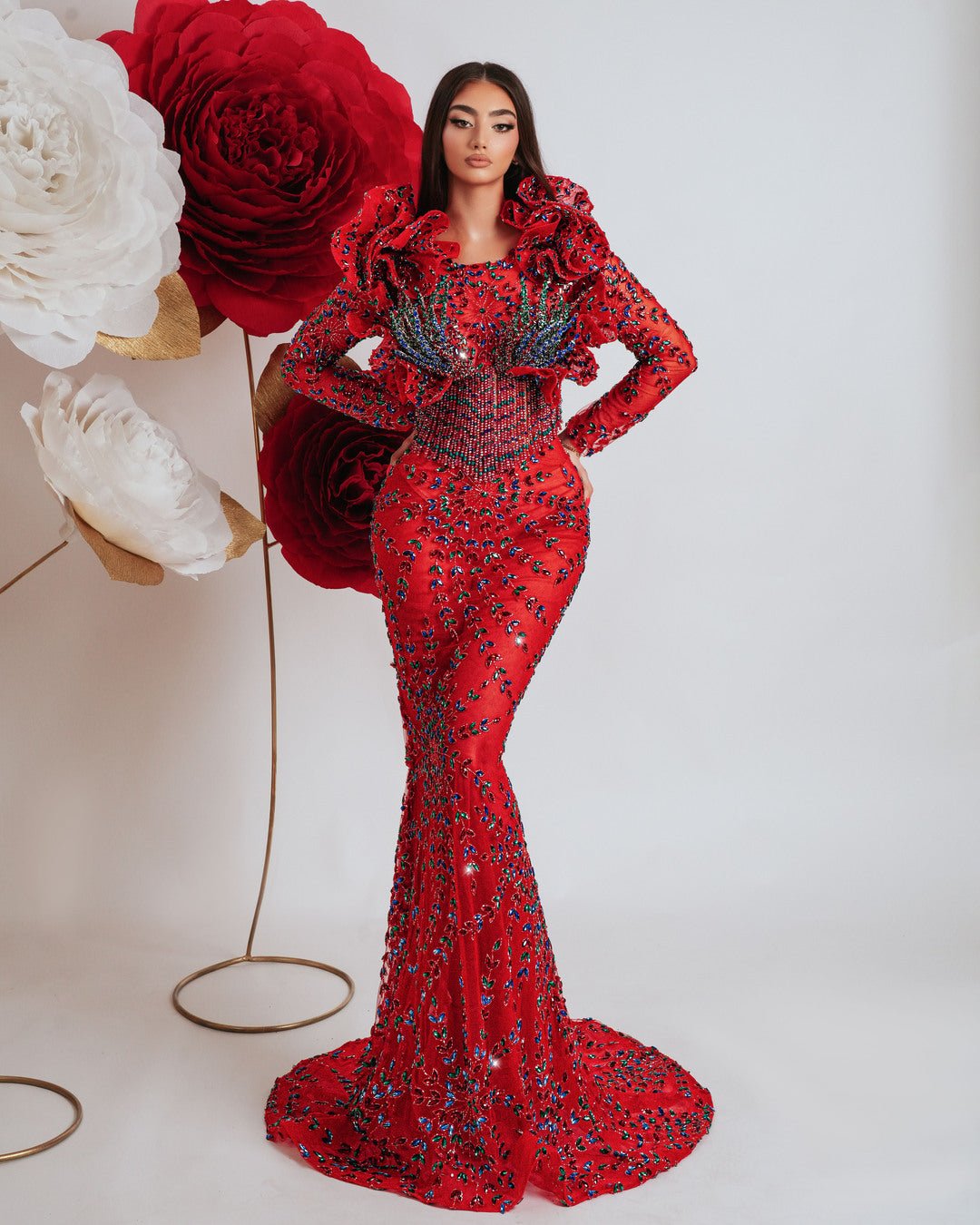 Elegant long red dress with long sleeves, colorful stones, and 3D ruffle shoulders