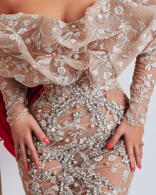 Close-up of silver crystal embellishments on beige off shoulder dress