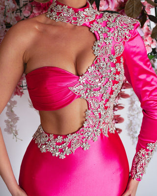 Close-up view of satin pink dress with intricate silver stone embellishments