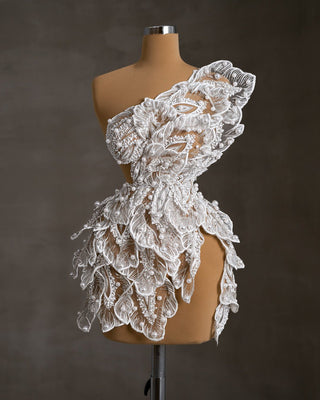 Luxurious white lace bride-to-be dress adorned with pearls.