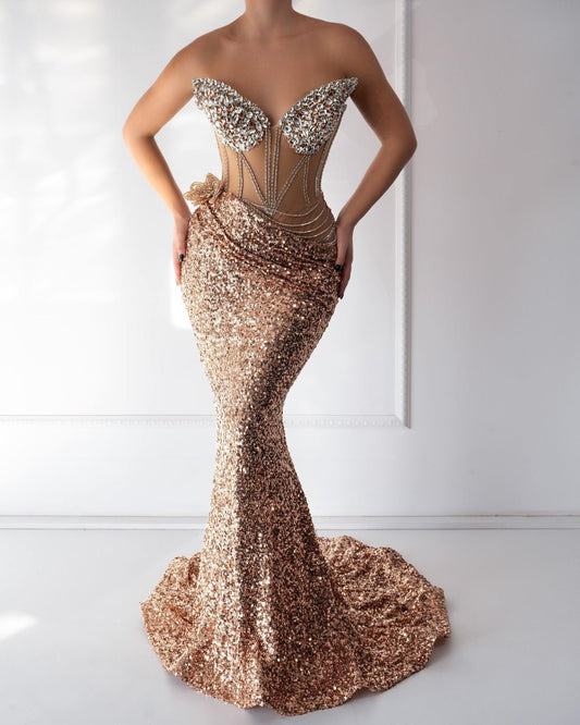 A luxurious gold satin dress adorned with sparkling crystals, featuring a flattering silhouette and elegant draping.






