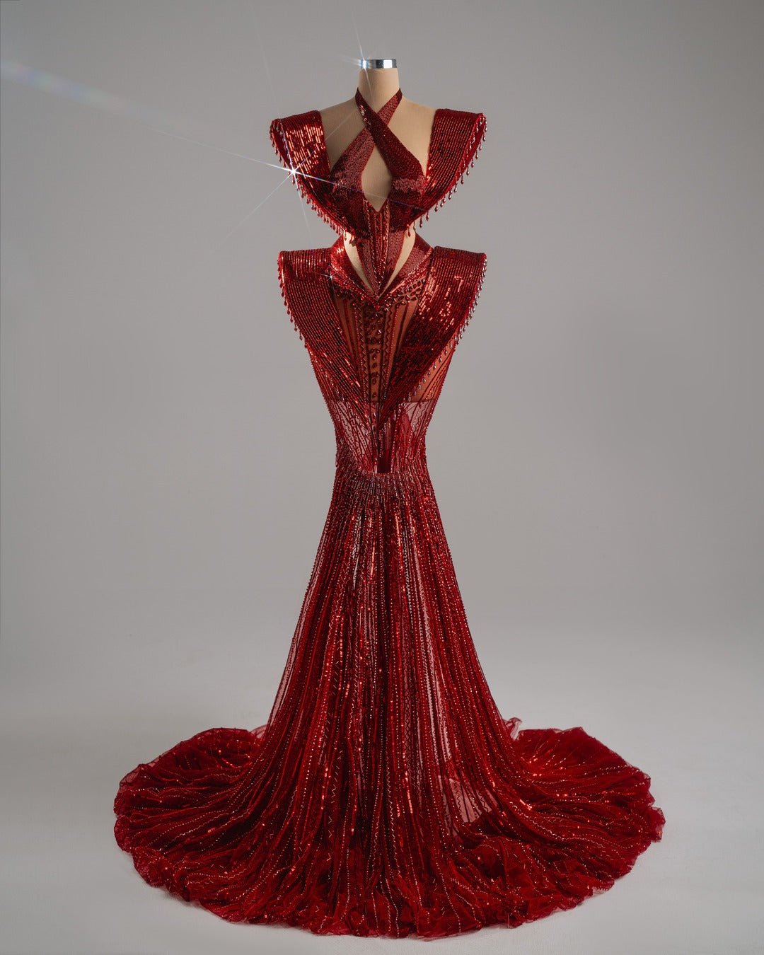 Sculptural gown with halter neckline and cutouts.