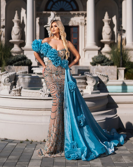 A flowing blue gown adorned with shimmering crystal waves, embodying grace and allure.