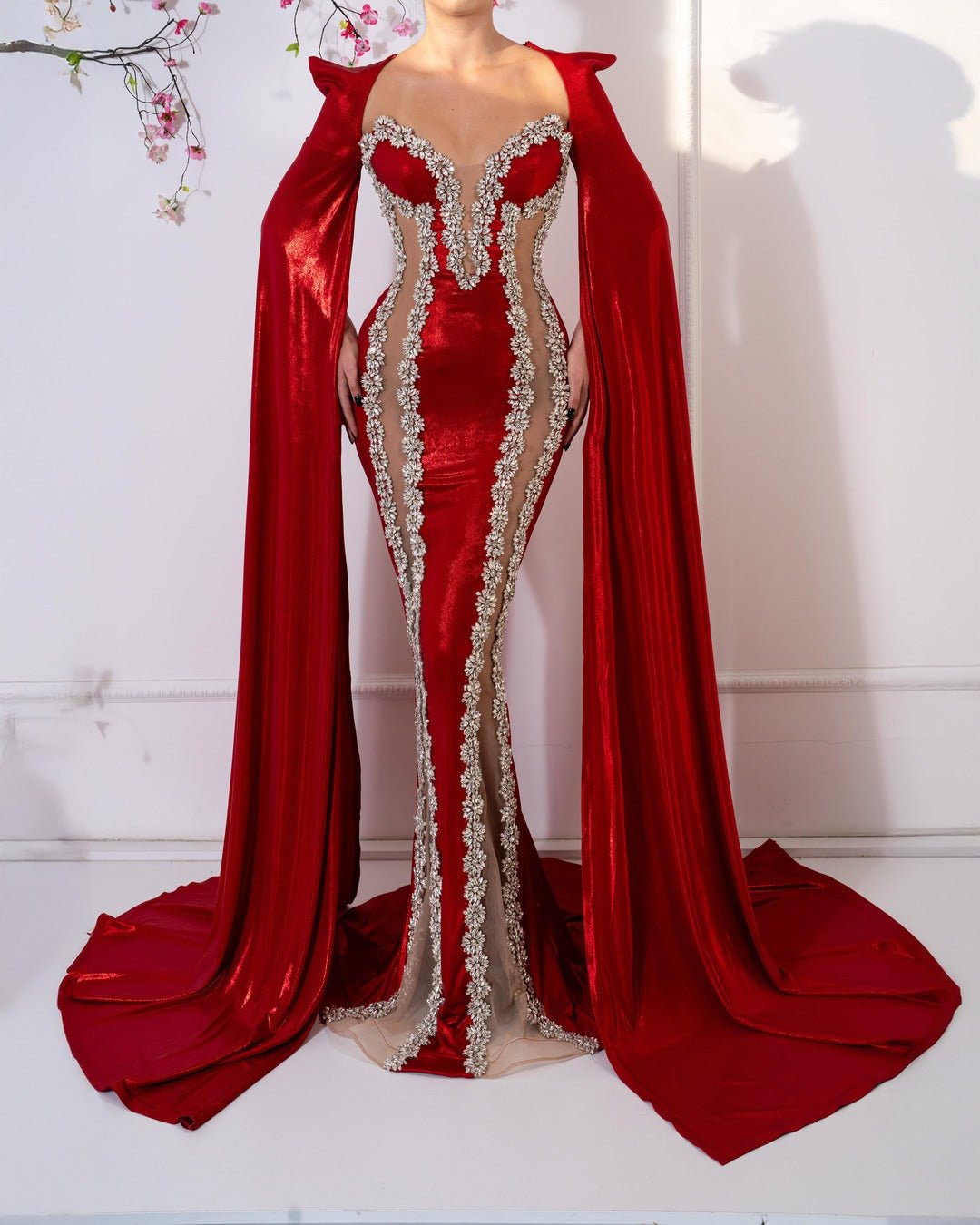 Elegant red dress with long sleeves and sparkling crystal embellishments.