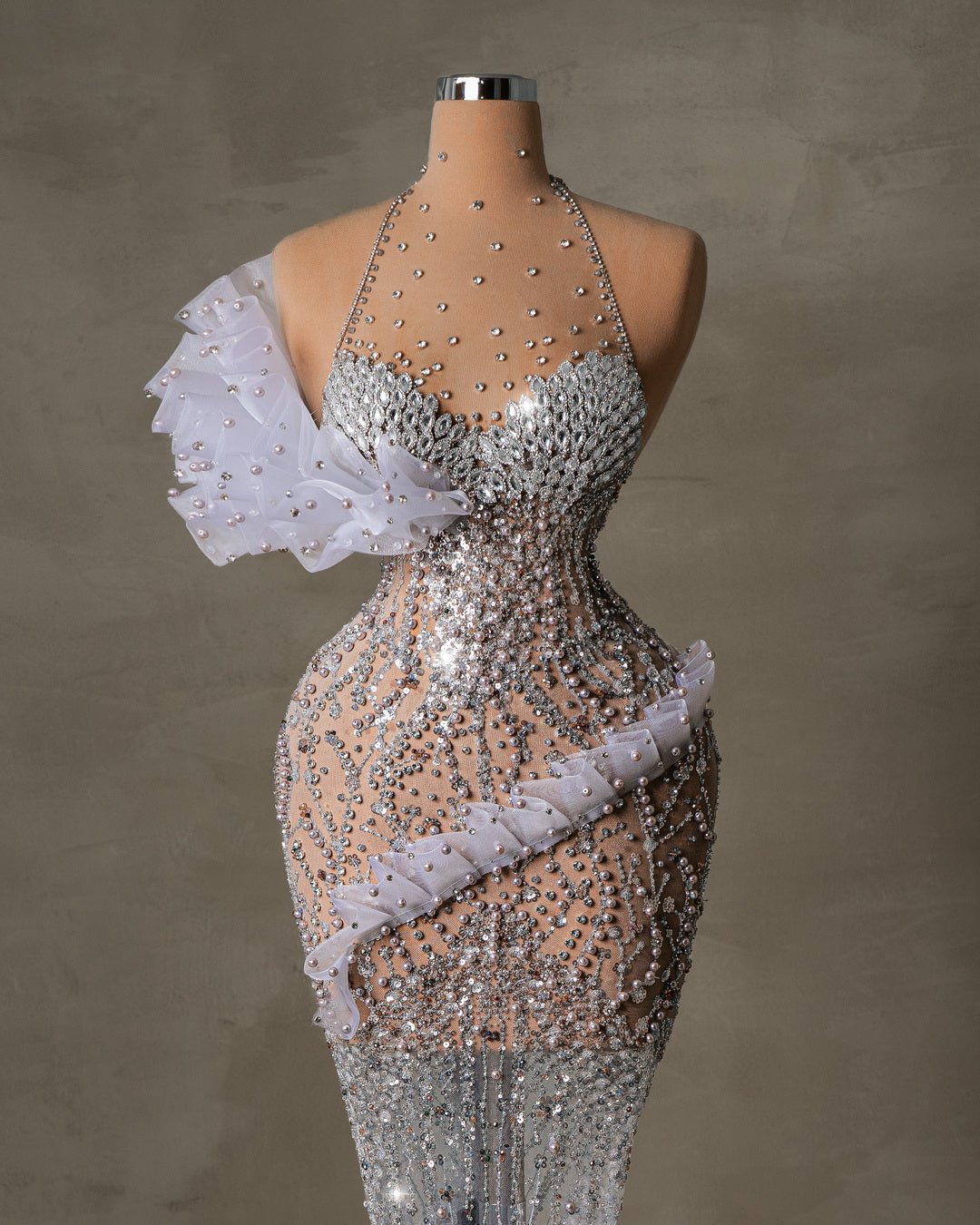 Sparkling halter dress with crystal embellishments and ruffle accents.