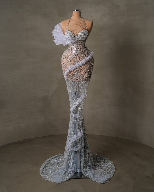 Elegant halter gown featuring cascading crystals and delicate ruffles.