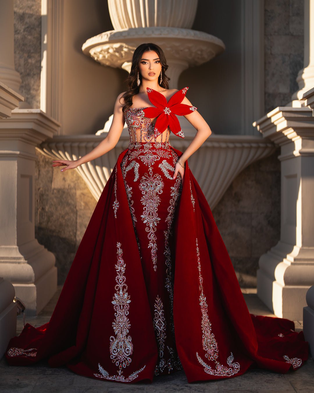 Regal red gown with silver embroidery and crystal embellishments.
