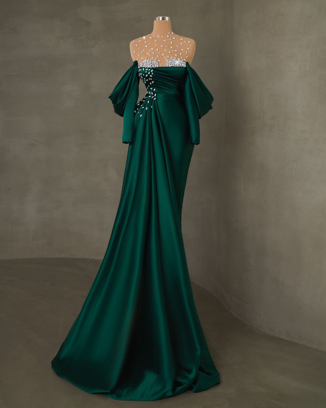 Luxury satin gown in emerald green with side tail and long sleeves