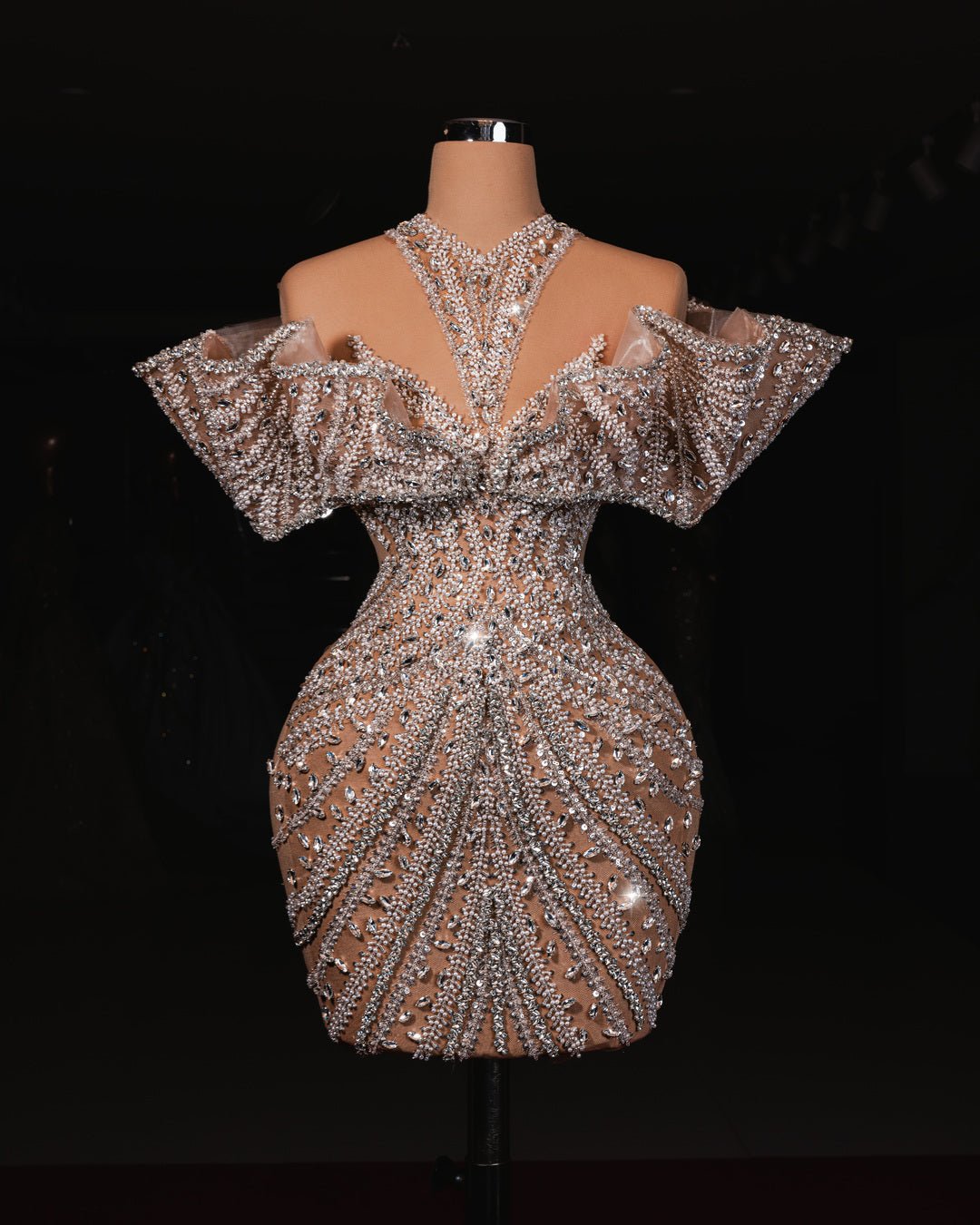 A handmade short off-shoulder dress adorned with shimmering crystals, perfect for elegant occasions.