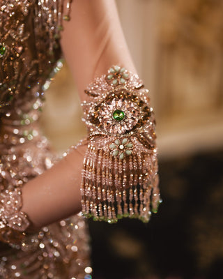 Close-up of silver and gold bead embellishments on pink dress