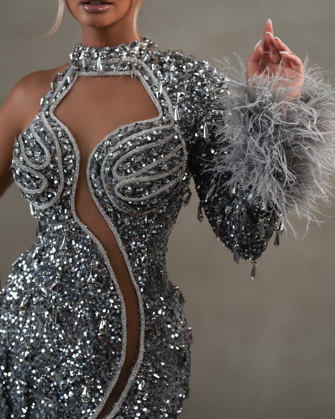 Close-Up of Silver Feathers on Sleeve of Sequin Dress