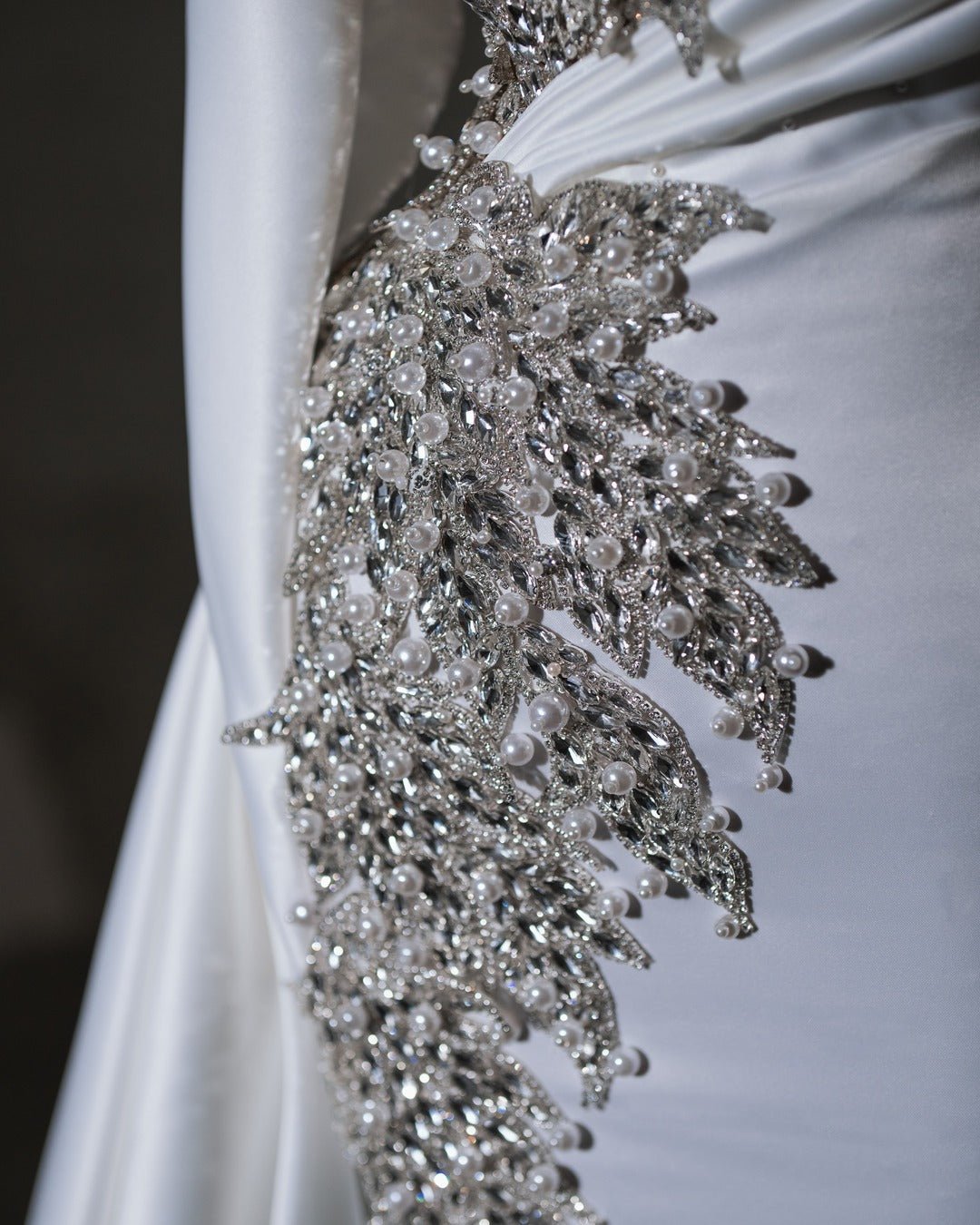 Sophisticated bridal dress with a flattering silhouette and intricate crystal and pearl details.